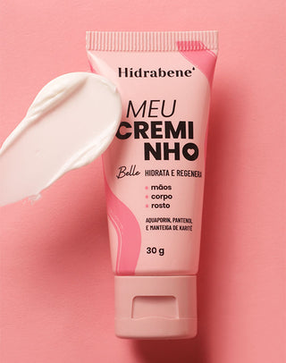 Meu Creminho Belle Hidrabene sobre fundo rosa com textura cremosa