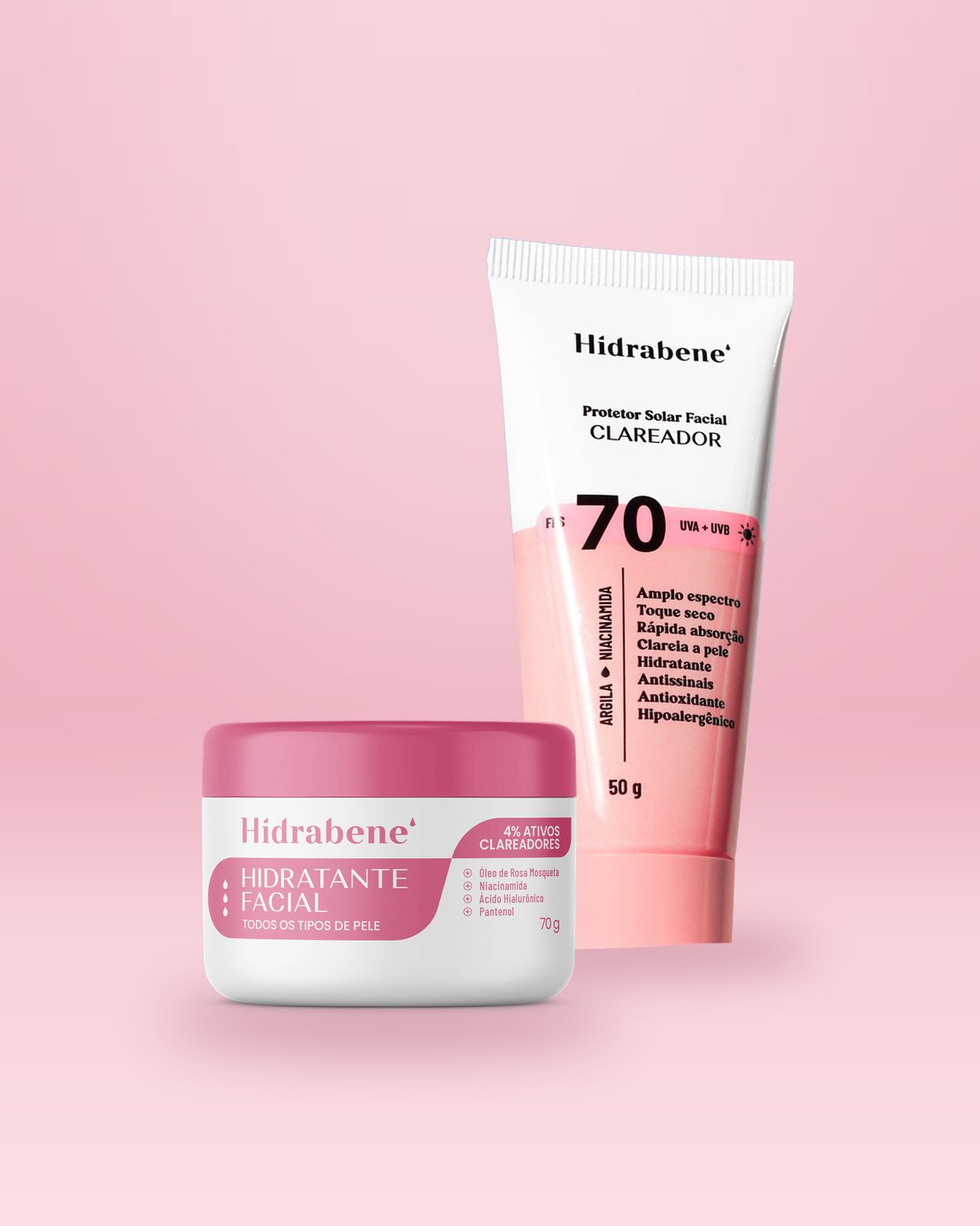 Pote do Hidratante Facial Clareador 70g na frente da bisnaga do Protetor Solar FPS 70 Clareador 50g, em fundo rosa